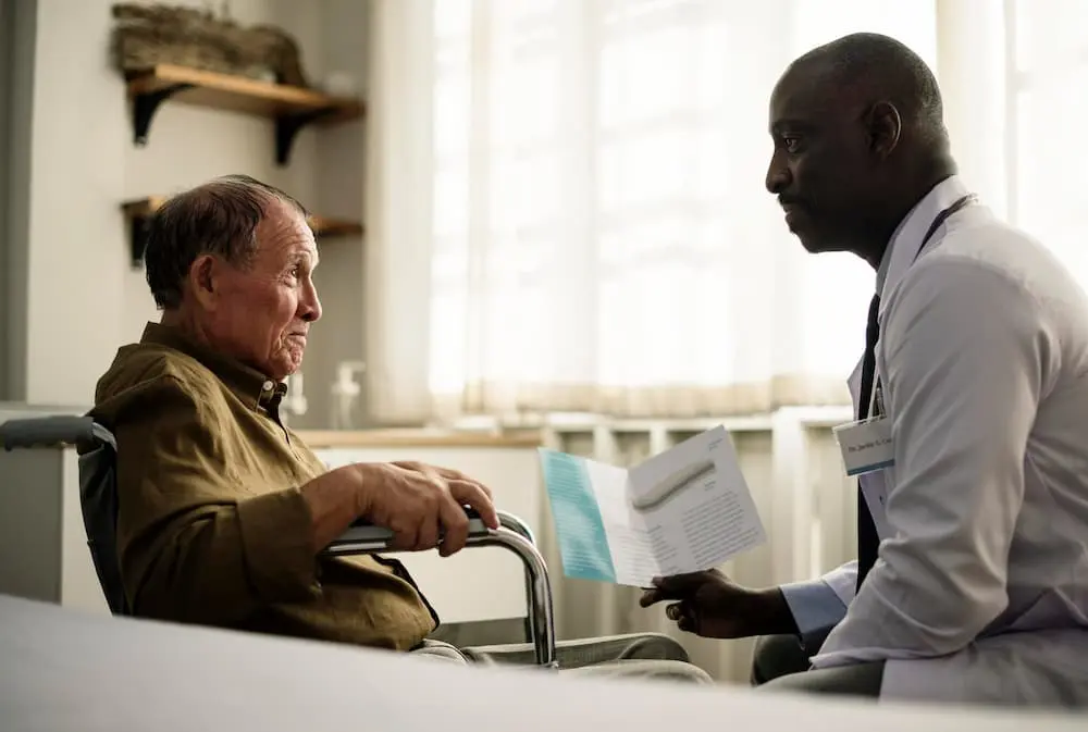 Internist in 3071 Perry Ave, Bronx, NY 10467 — a physician discusses care options with a senior in a wheelchair, emphasizing internal medicine and geriatric care.