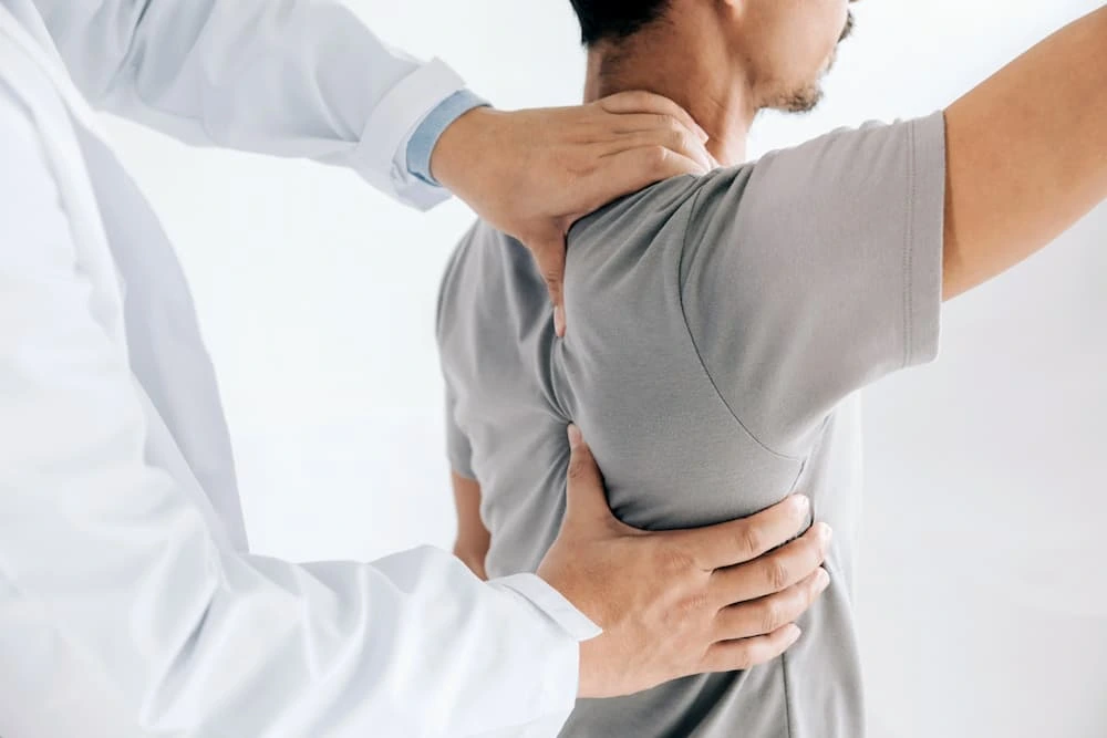 Physical therapy in 3071 Perry Ave, Bronx, NY 10467 — a physical therapist guiding a patient through shoulder mobility exercises, representing personalized rehabilitation and pain relief.